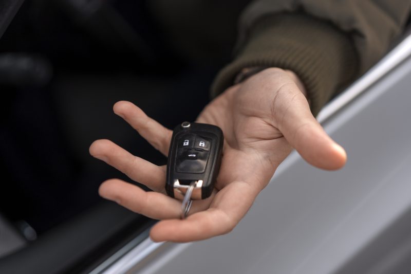 man holding a modern car key